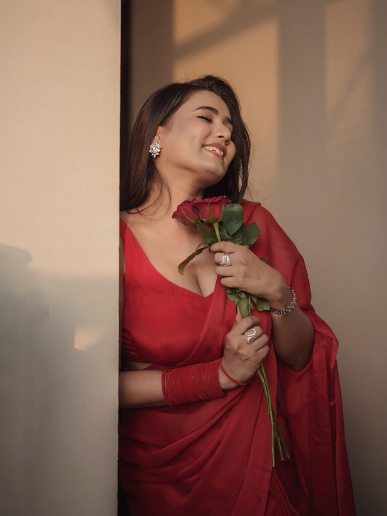garima chaurasia red saree holding roses photoshoot